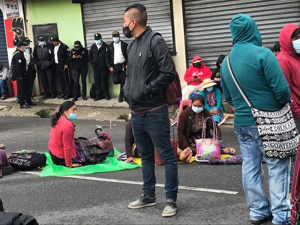  Mujeres reposan durante el paro. Atrás, agentes de la PNC se relajan.Foto: Paolina Albani. 