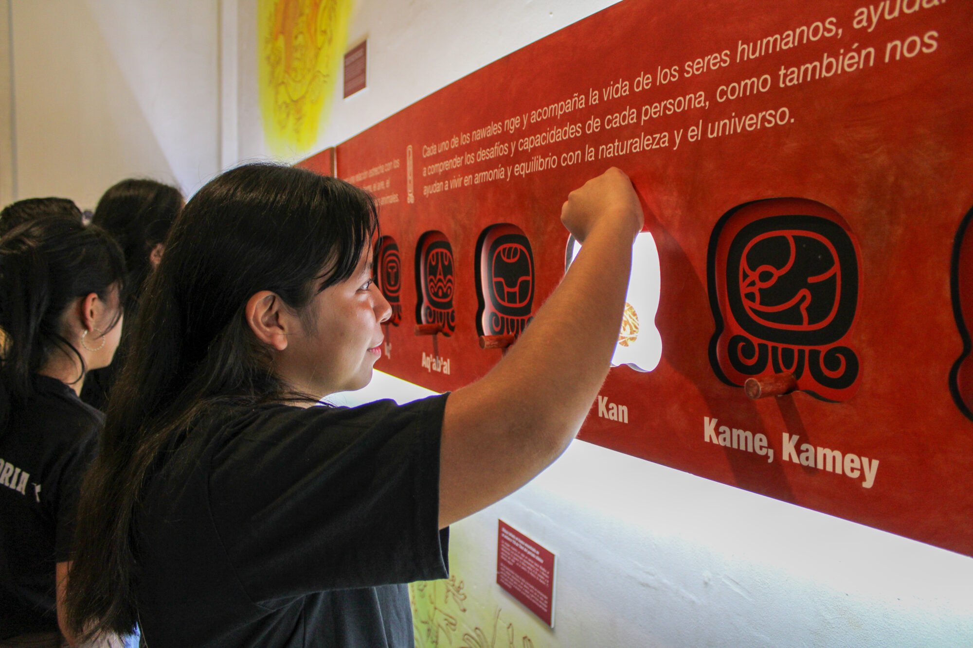  Una joven interactúa con una exhibición sobre los nawales mayas, explorando su significado y conexión con la naturaleza. Foto de Derik Mazariegos 