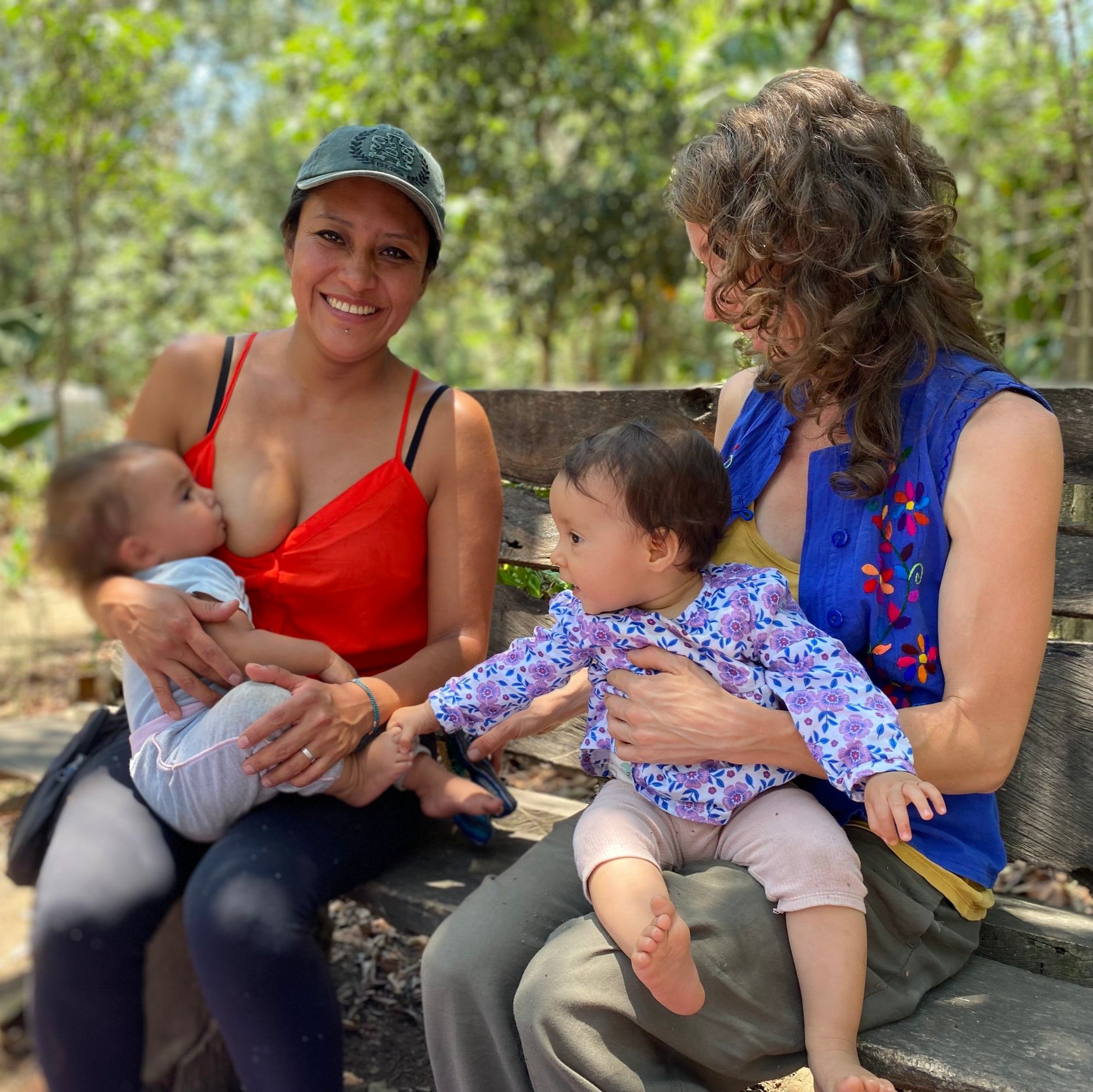  Libertad amamantando a su beba, mientras Eli le agarra de los piesitos en brazos de su madre Nolwenn. Fotografía: Ketzali Pérez. 